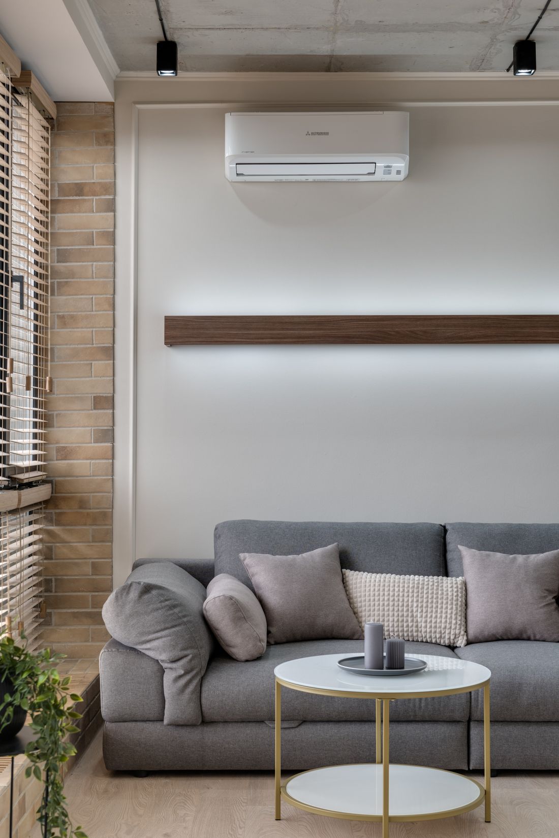 Climatiseur mural installé au-dessus d'un canapé